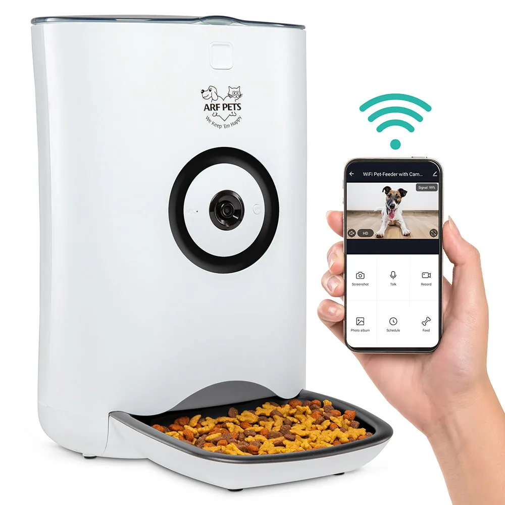 An automatic dog feeder with a camera placed in a cosy living room.