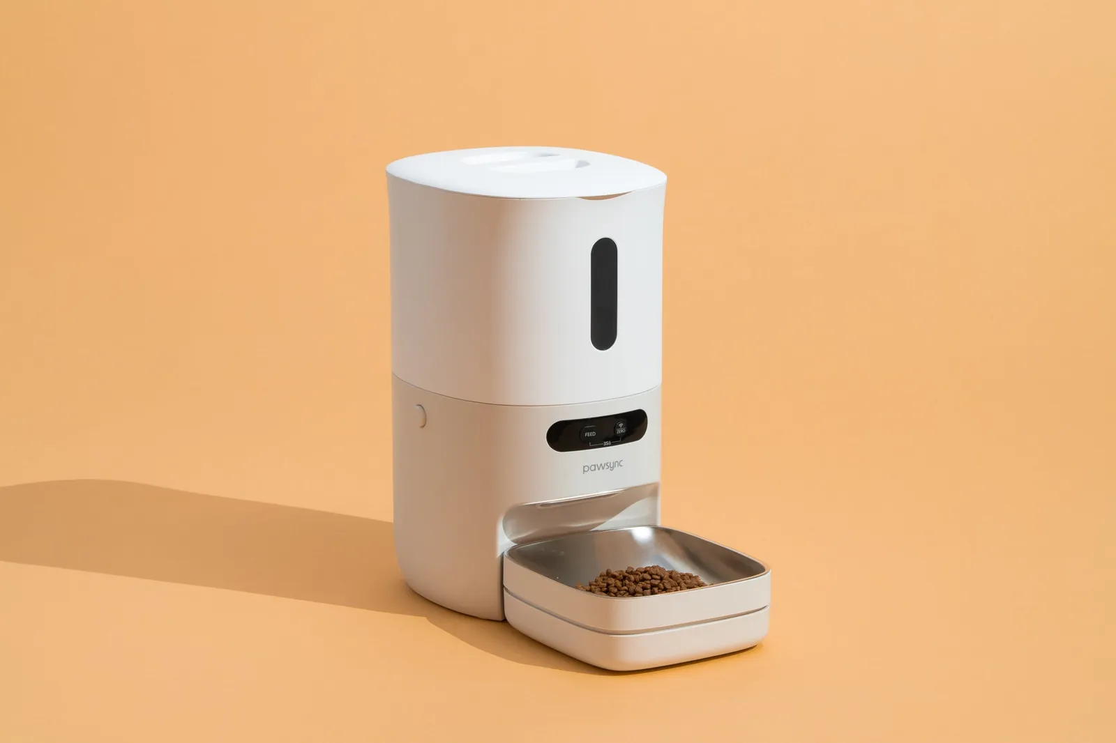 Measuring dry pet food on a scale before filling an automatic feeder.