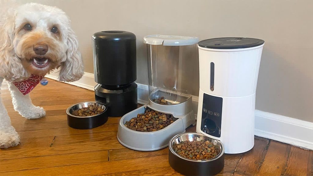 A modern automatic dog feeder with a camera sitting in a bright kitchen.